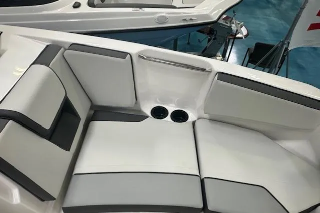 Slide: The Image of 2025 Yamaha Boats AR220 interior seating with cup holders, showcasing modern design and comfort. - 15