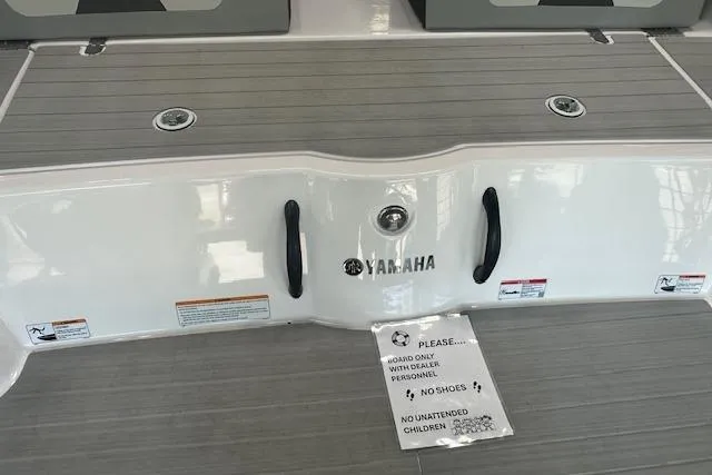 Slide: The Image of 2025 Yamaha Boats AR220 deck with safety notice and sleek design. - 6