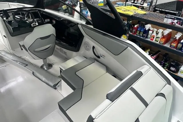 Slide: The Image of 2025 Yamaha Boats AR220 interior with sleek seating and modern dashboard design. - 8