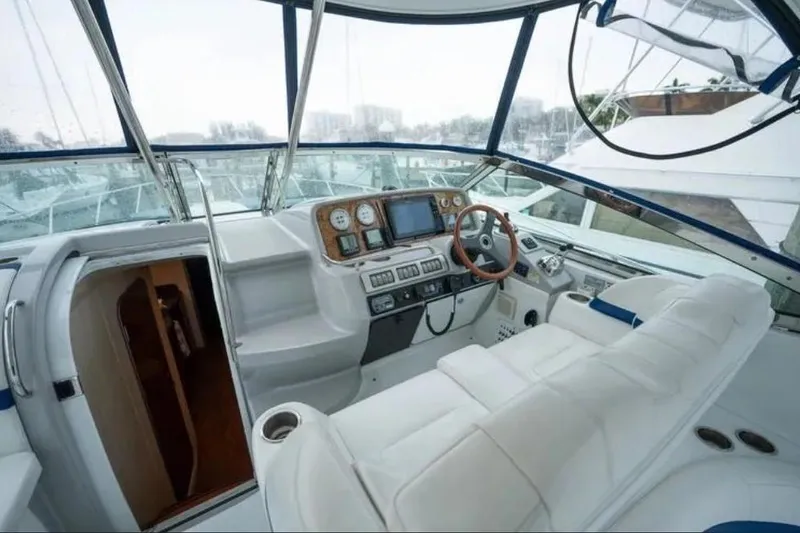 Slide: The Image of 2008 Formula 40 Performance Cruiser docked in a marina with cityscape background. - 6