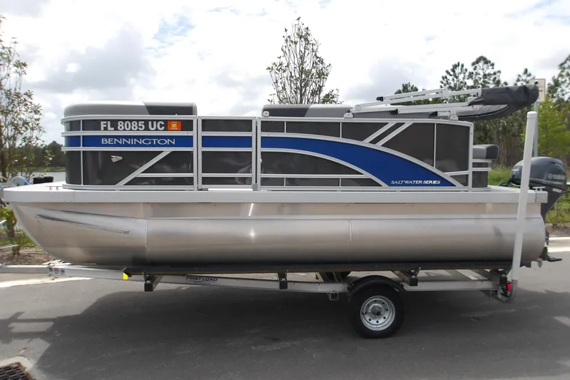 The Image of 2026 Bennington 16 S L-Bench pontoon boat on trailer, side view. - 0