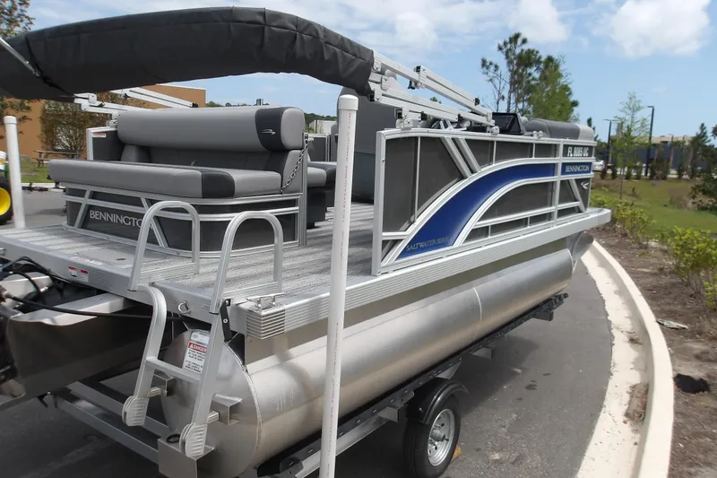 Slide: The Image of 2026 Bennington 16 S L-Bench pontoon boat with sleek design on a trailer. - 7