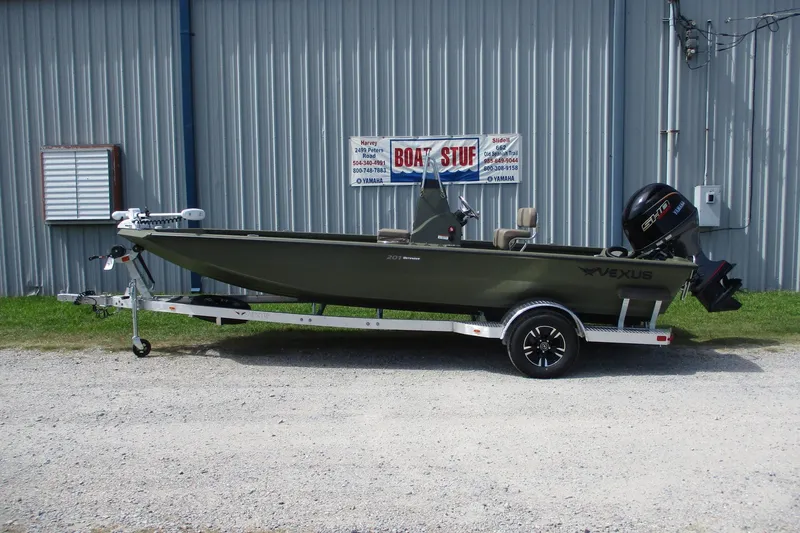 The Image of 2026 Vexus Defender 201 boat on trailer, parked outside a metal building. - 0