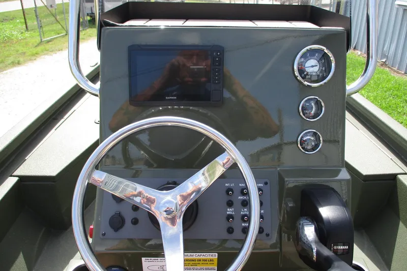 Slide: The Image of Steering console of 2026 Vexus Defender 201 boat with gauges and Garmin display. - 13