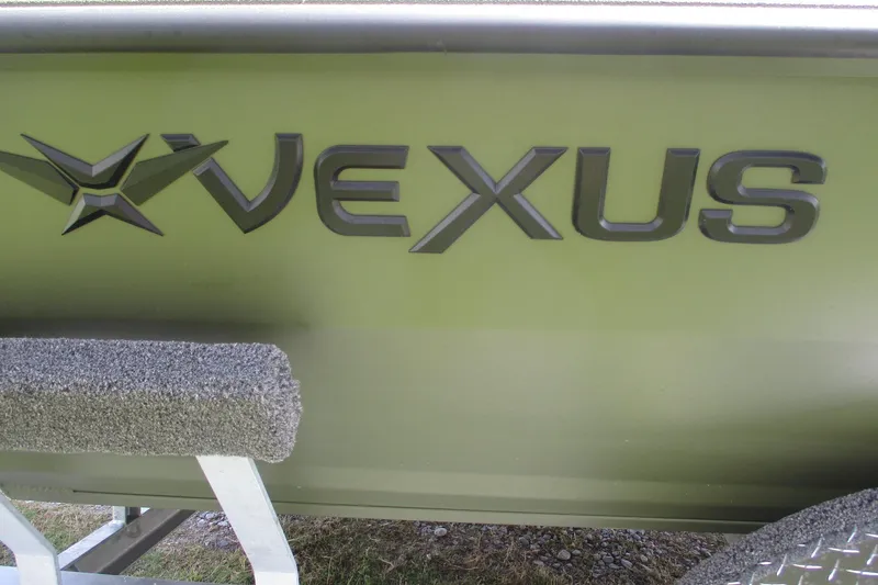 Slide: The Image of Close-up of 2026 Vexus Defender 201 boat logo on green hull. - 16