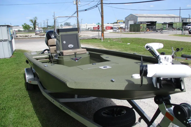 Slide: The Image of 2026 Vexus Defender 201 boat on trailer, parked outdoors, showcasing sleek design and modern features. - 2
