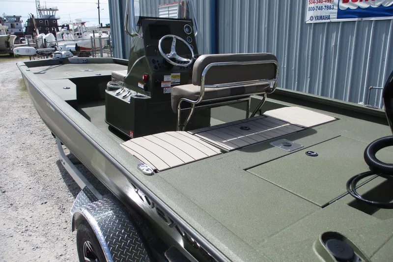 Slide: The Image of 2026 Vexus Defender 201 boat with sleek design and modern console, parked outdoors. - 5