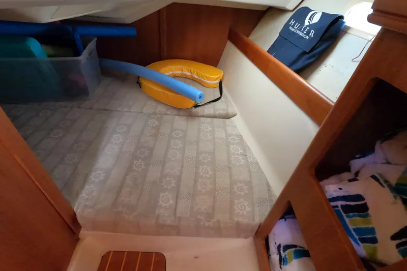 Slide: The Image of Interior cabin of 2003 Hunter 326 sailboat with storage and nautical accessories. - 13