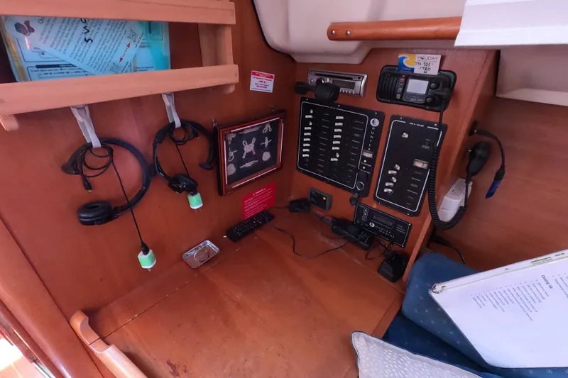 Slide: The Image of Control panel of a 2003 Hunter 326 sailboat with communication equipment and wiring. - 15