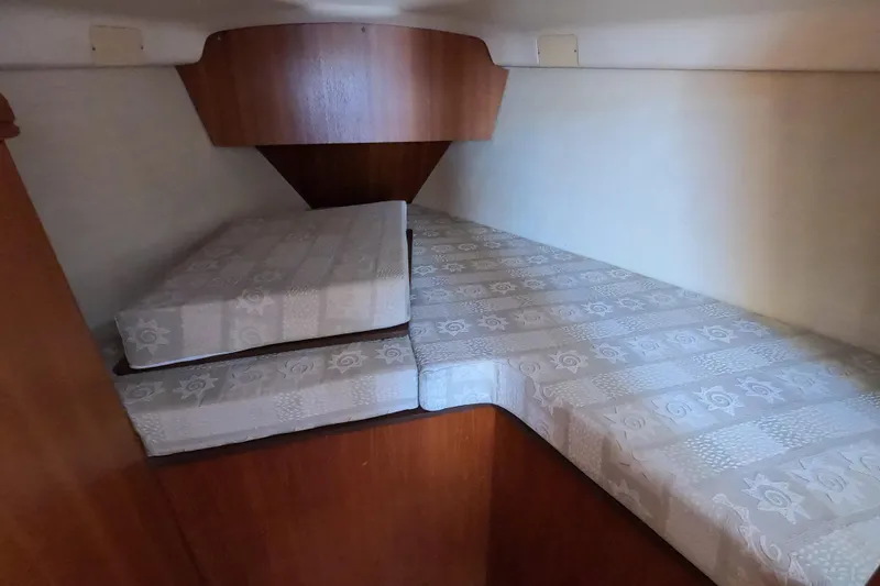 Slide: The Image of Interior cabin of 2003 Hunter 326 sailboat with patterned cushions. - 19