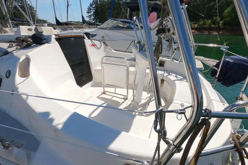 Slide: The Image of 2003 Hunter 326 sailboat cockpit with stainless steel fittings and seating area. - 2