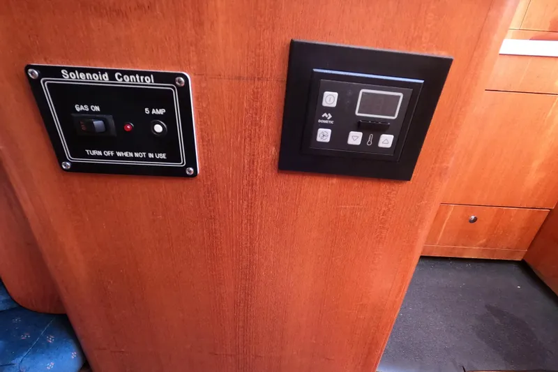 Slide: The Image of Control panels on a 2003 Hunter 326 boat interior, featuring solenoid and Dometic controls. - 22