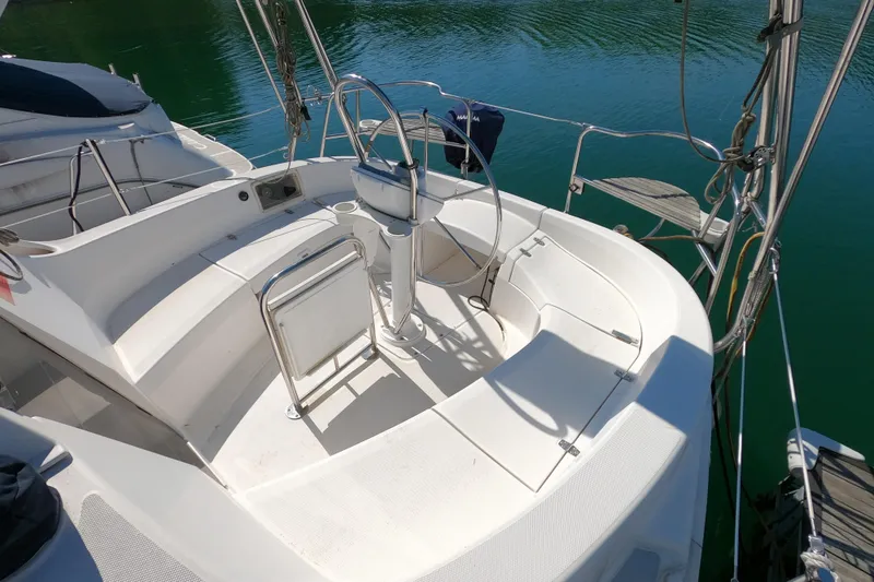 Slide: The Image of Cockpit of a 2003 Hunter 326 sailboat with steering wheel and seating. - 3