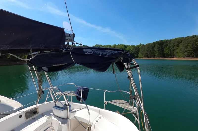 Slide: The Image of Sailboat on tranquil lake with forested shoreline, Hunter 326 model, 2003. - 5