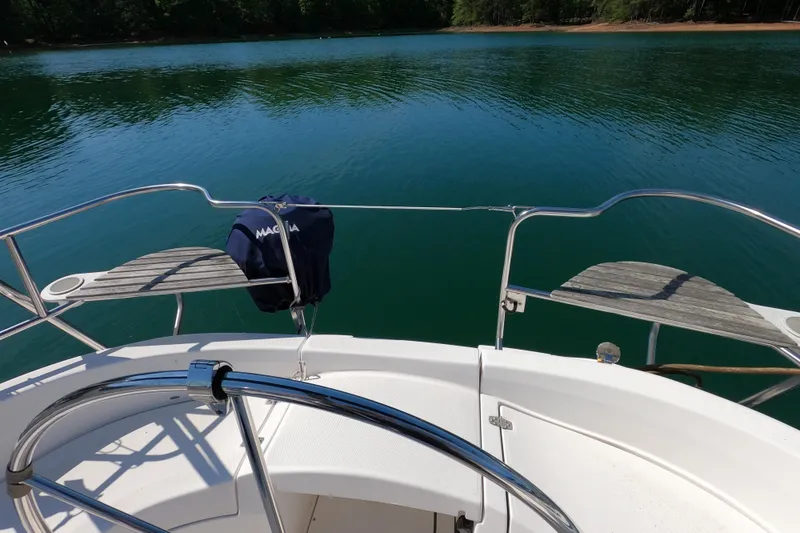 Slide: The Image of Bow view of 2003 Hunter 326 sailboat on calm lake waters. - 6