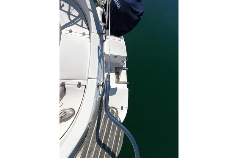 Slide: The Image of Deck view of a 2003 Hunter 326 sailboat with blue water background. - 7