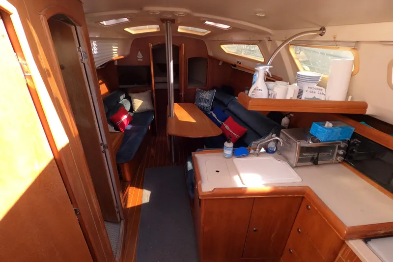 Slide: The Image of Interior of 2003 Hunter 326 sailboat with cozy seating and kitchenette. - 9