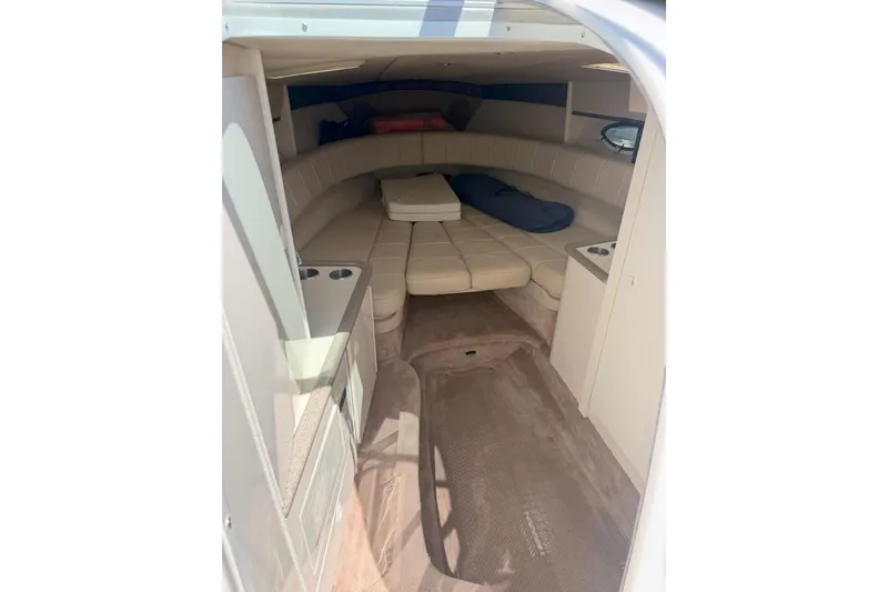 Slide: The Image of Interior cabin of 2001 Formula 330 Sun Sport boat, featuring beige seating and compact design. - 11
