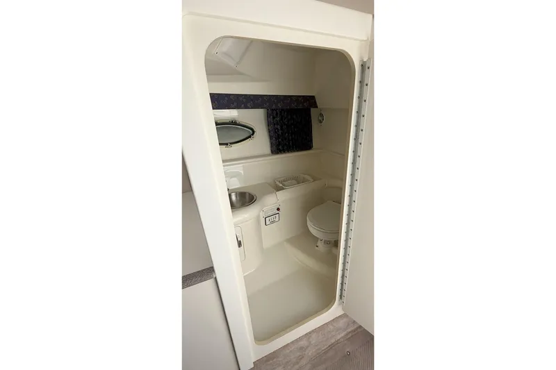 Slide: The Image of 2001 Formula 330 Sun Sport boat bathroom with sink, toilet, and mirror. - 13