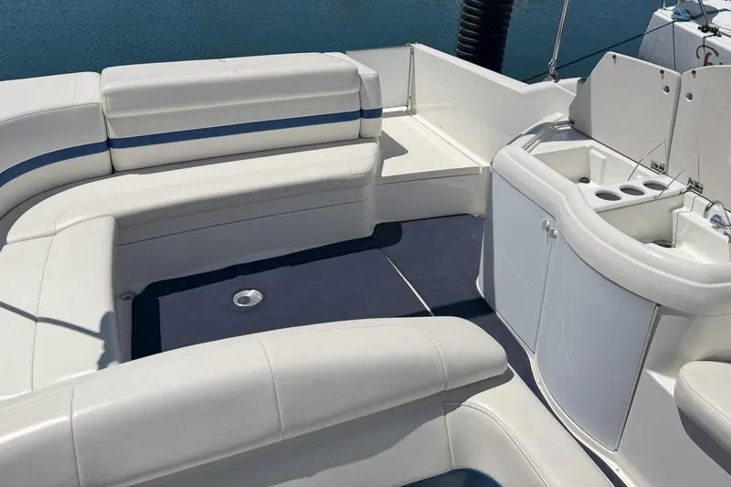 Slide: The Image of 2001 Formula 330 Sun Sport boat interior with white seating and compact kitchenette. - 3