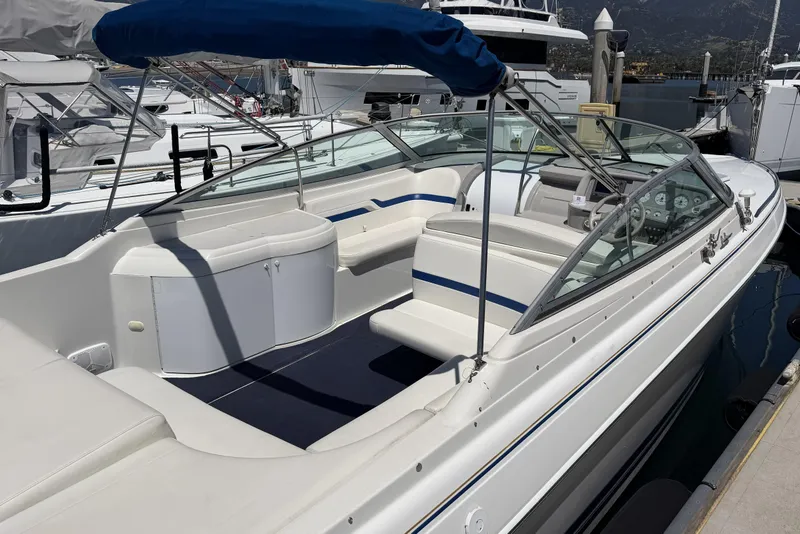 Slide: The Image of 2001 Formula 330 Sun Sport boat docked, featuring spacious seating and sleek design. - 6