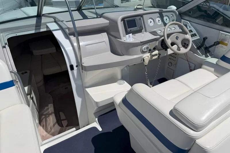 Slide: The Image of 2001 Formula 330 Sun Sport boat interior with helm, seating, and cabin entrance. - 8