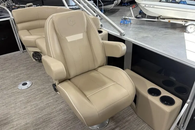 Slide: The Image of Luxurious seating on 2026 Godfrey Xperience 2086 SBX boat, featuring beige upholstery and cup holders. - 12