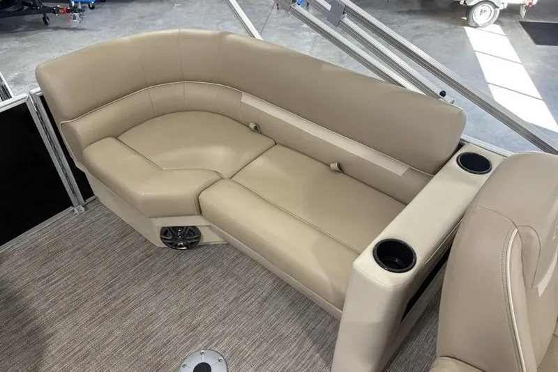 Slide: The Image of Luxurious seating on 2026 Godfrey Xperience 2086 SBX pontoon boat, featuring beige upholstery and cup holders. - 14