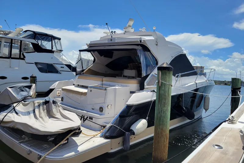 Slide: The Image of 2012 Four Winns V435 yacht docked at marina under clear blue sky. - 36