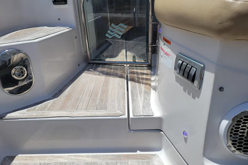 Slide: The Image of 2012 Four Winns V435 boat interior with wooden steps and control panel. - 38