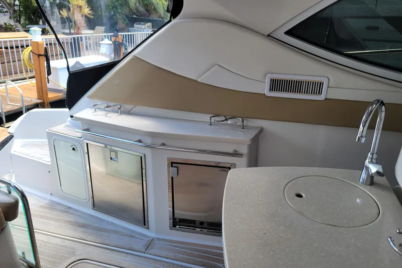 Slide: The Image of 2012 Four Winns V435 yacht interior with kitchenette, sink, and storage compartments. - 39