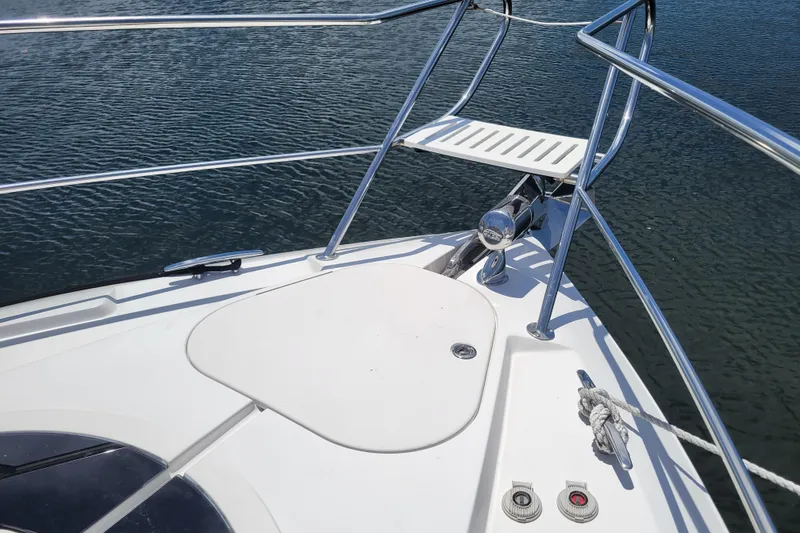 Slide: The Image of Bow of 2012 Four Winns V435 yacht with stainless steel railings on water. - 40