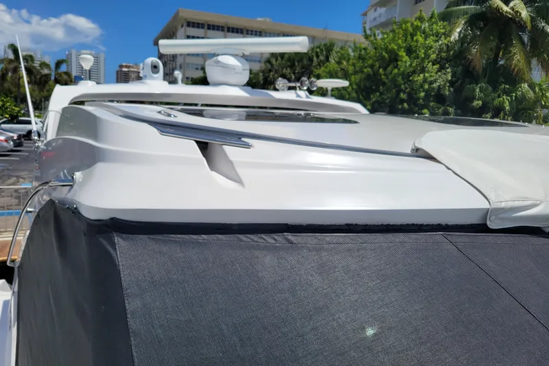 Slide: The Image of 2012 Four Winns V435 yacht exterior with sleek design, docked under clear blue sky. - 42