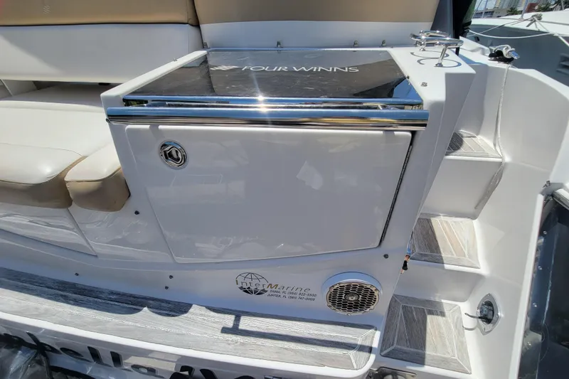 Slide: The Image of 2012 Four Winns V435 boat interior with seating and storage area. - 43