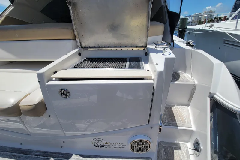 Slide: The Image of 2012 Four Winns V435 yacht with outdoor grill and seating area. - 45