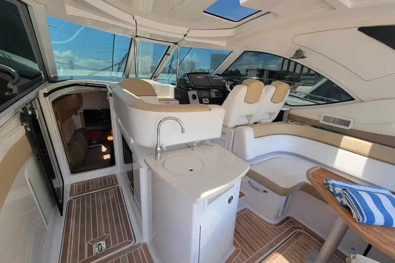 Slide: The Image of Interior of 2012 Four Winns V435 yacht with helm, seating, and kitchenette. - 47