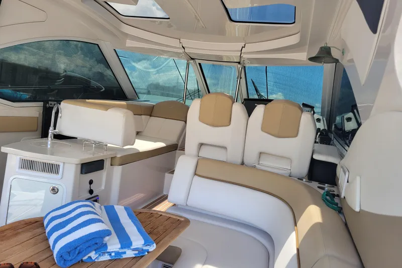 Slide: The Image of Interior of 2012 Four Winns V435 yacht with seating and striped towels. - 48