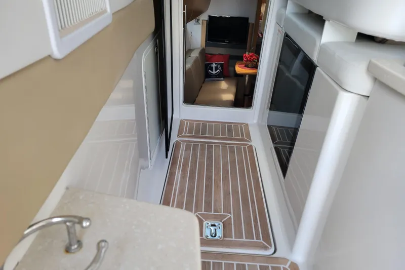 Slide: The Image of Interior of 2012 Four Winns V435 yacht with wood flooring and modern amenities. - 50