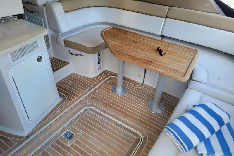 Slide: The Image of Luxurious 2012 Four Winns V435 yacht interior with wooden table and striped towel. - 51