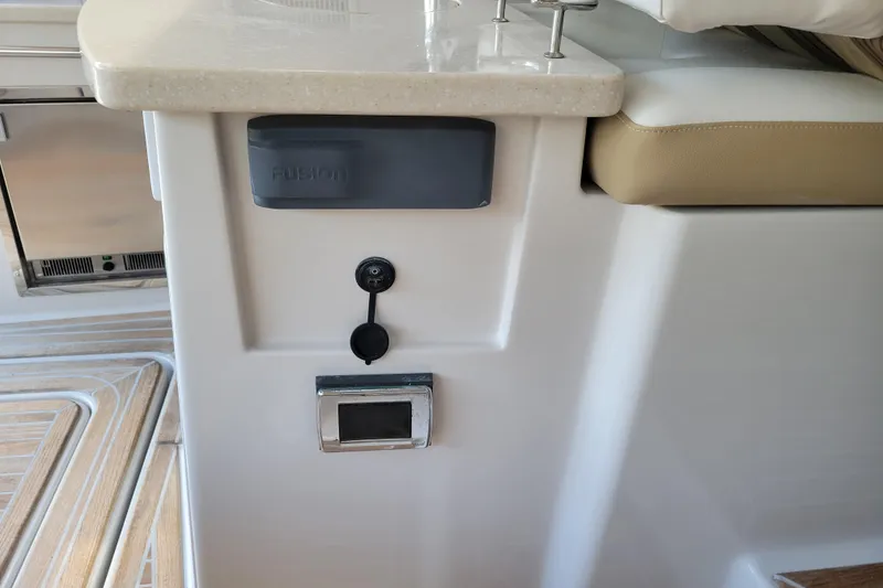 Slide: The Image of 2012 Four Winns V435 boat interior with Fusion audio system and seating area. - 54