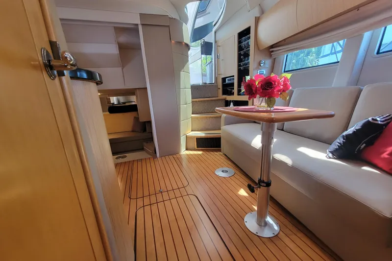 Slide: The Image of Luxurious 2012 Four Winns V435 yacht interior with elegant seating and wooden flooring. - 59