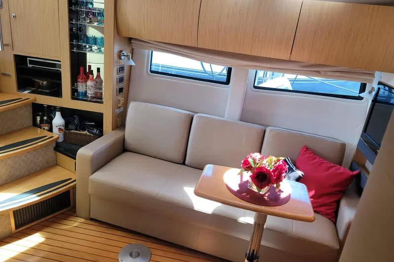 Slide: The Image of Luxurious interior of 2012 Four Winns V435 yacht with sofa, table, and bar area. - 61