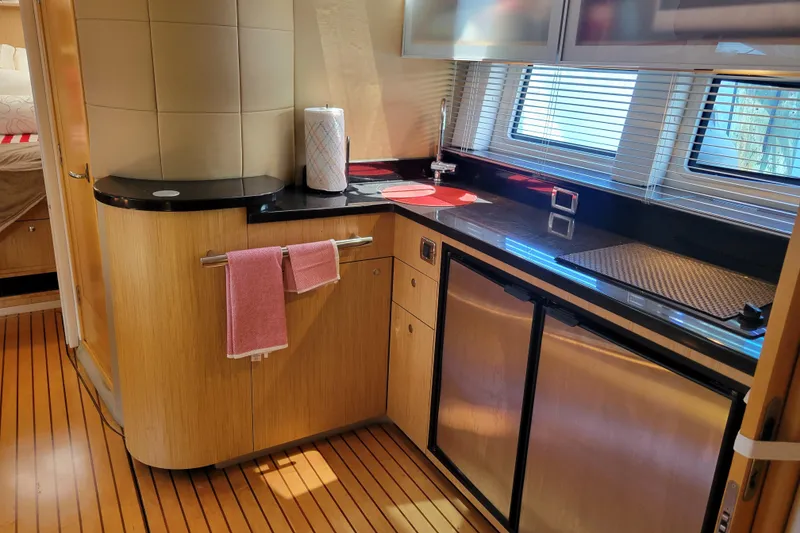 Slide: The Image of Luxurious 2012 Four Winns V435 yacht kitchen with sleek countertops and modern appliances. - 63