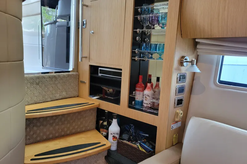 Slide: The Image of Interior of 2012 Four Winns V435 yacht with bar and wooden cabinetry. - 64