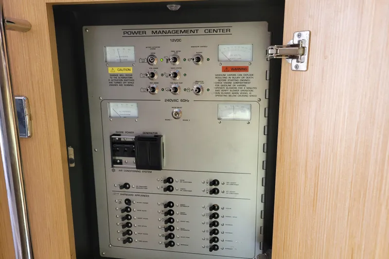 Slide: The Image of Power management center on 2012 Four Winns V435 boat, showing control panel and switches. - 65