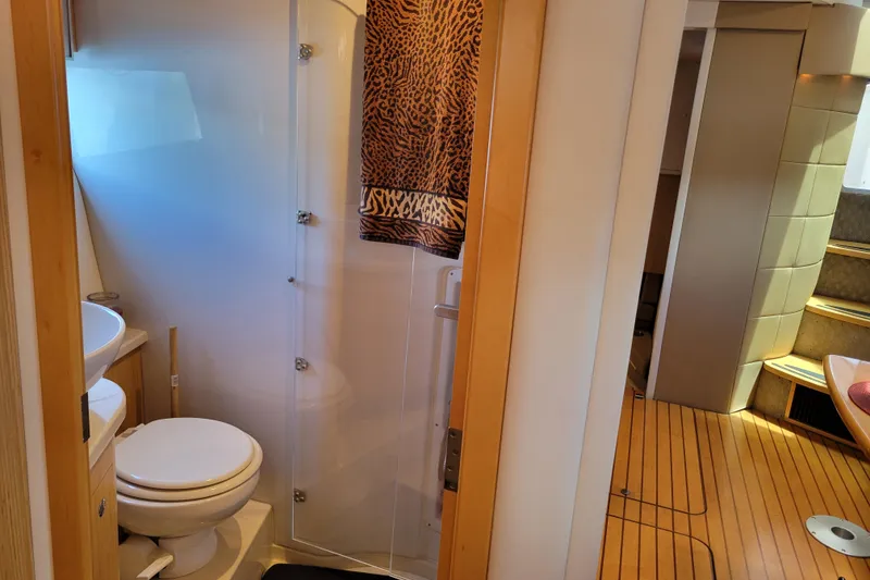 Slide: The Image of Bathroom interior of 2012 Four Winns V435 yacht with wooden flooring and modern fixtures. - 70