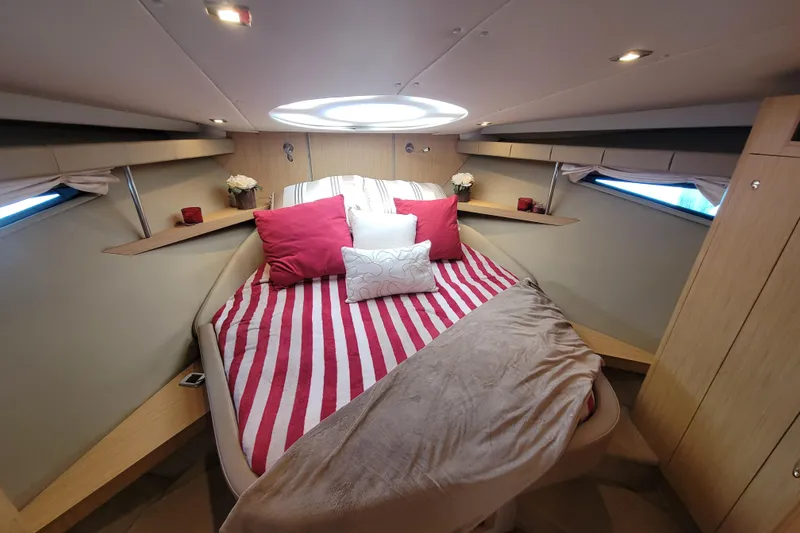 Slide: The Image of Luxurious 2012 Four Winns V435 yacht cabin with striped bedding and elegant decor. - 71