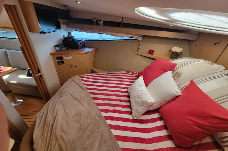 Slide: The Image of Luxurious 2012 Four Winns V435 yacht cabin with striped bedding and cozy decor. - 72