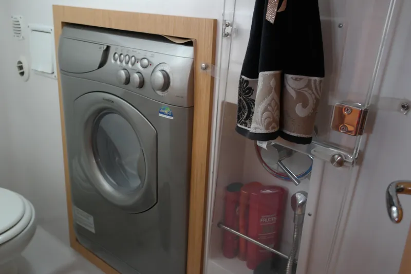 Slide: The Image of Laundry area in 2012 Four Winns V435 boat with washing machine and towels. - 74