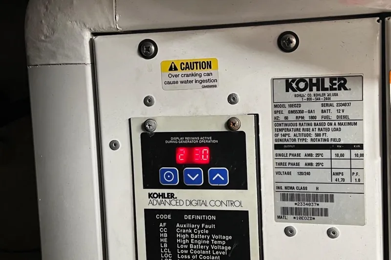 Slide: The Image of Kohler generator control panel on 2012 Four Winns V435 boat, displaying caution and specifications. - 79